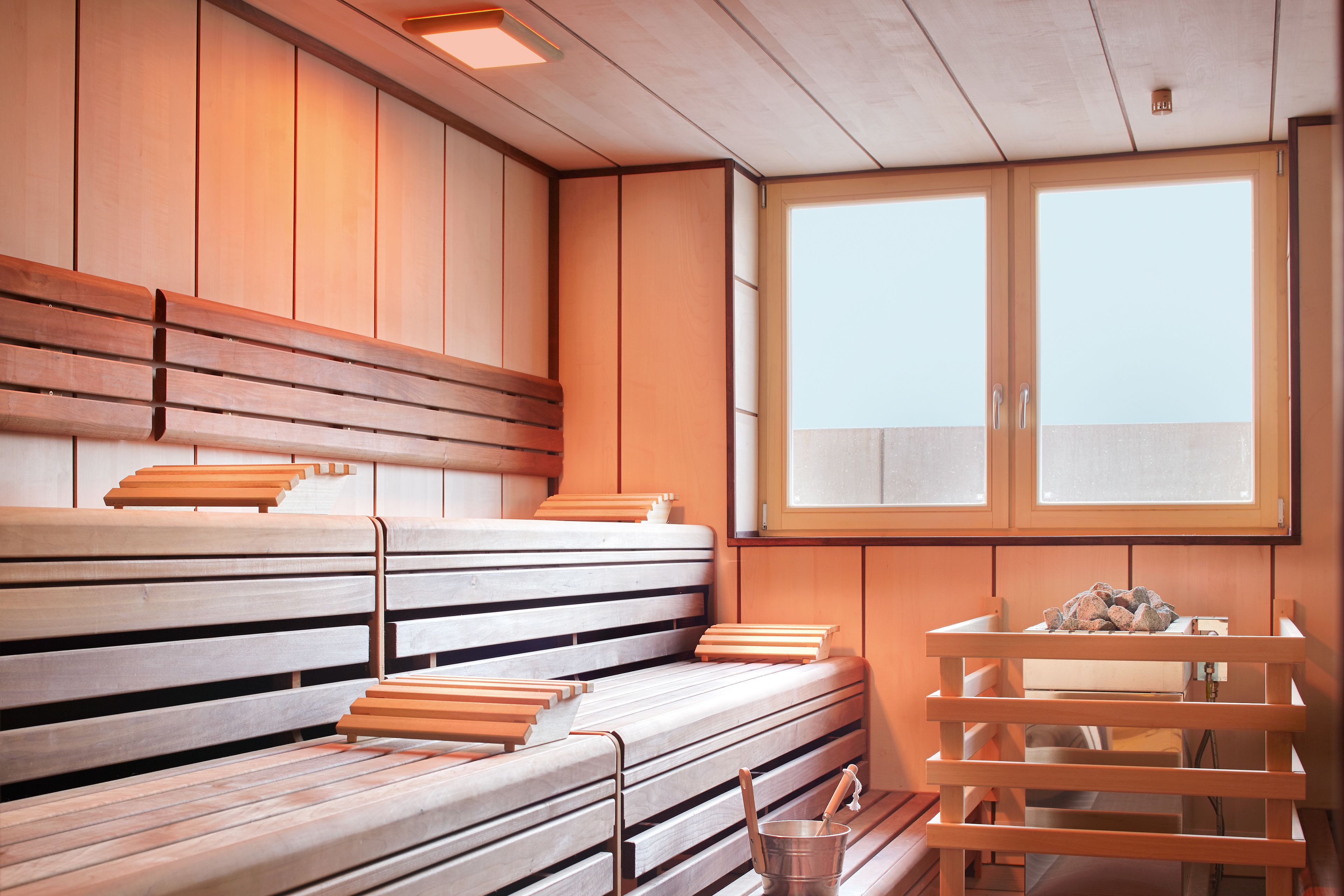 A sauna with wooden benches and a window.