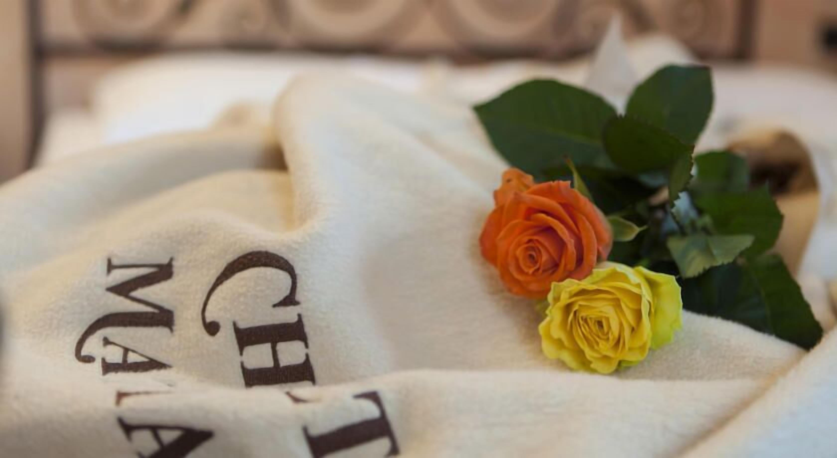 A white blanket with the text "CHILD MAIDEN" and two roses.