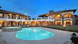 A large outdoor swimming pool surrounded by a courtyard with multiple buildings, each with balconies and large windows. - Tota Virginia Antico Podere (Serralunga d'Alba)
