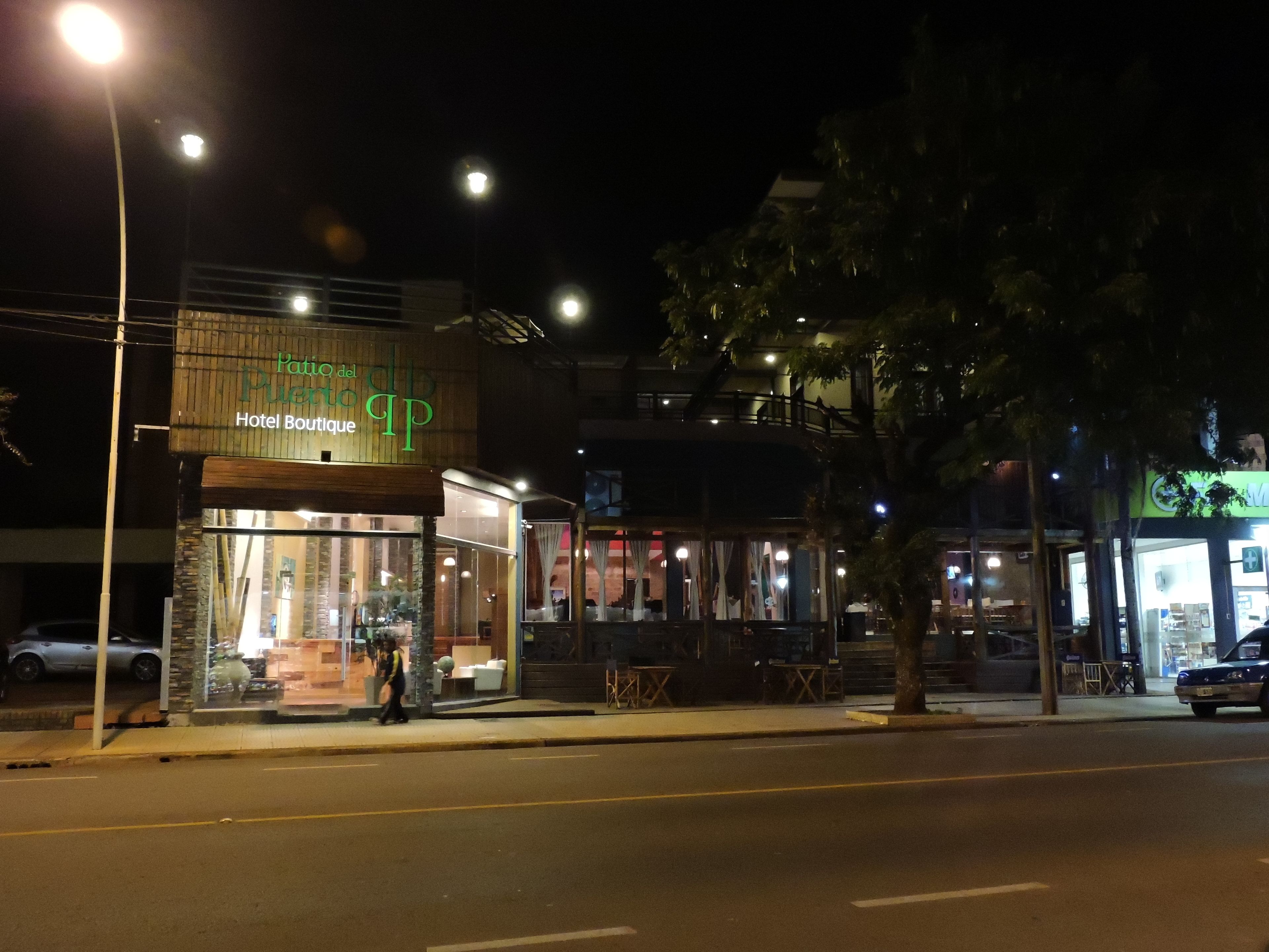 A hotel named 'Hotel Boutique' with a visible storefront and outdoor seating area.