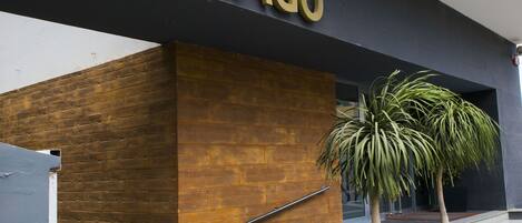 A modern hotel entrance with a prominent sign reading "HOTEL SANTIAGO".