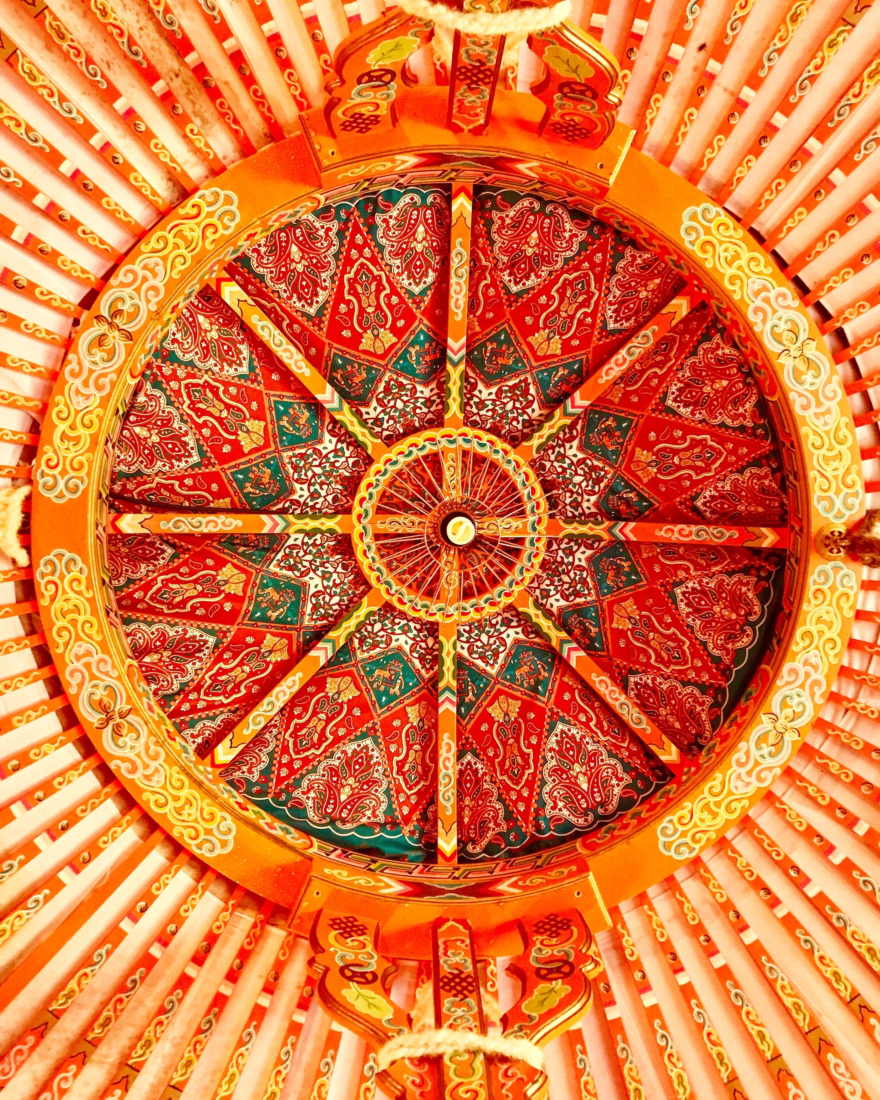 A circular, ornate ceiling with intricate patterns and a central circular design.