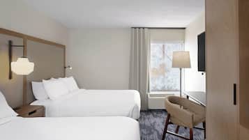 Premium bedding, desk, laptop workspace, blackout drapes