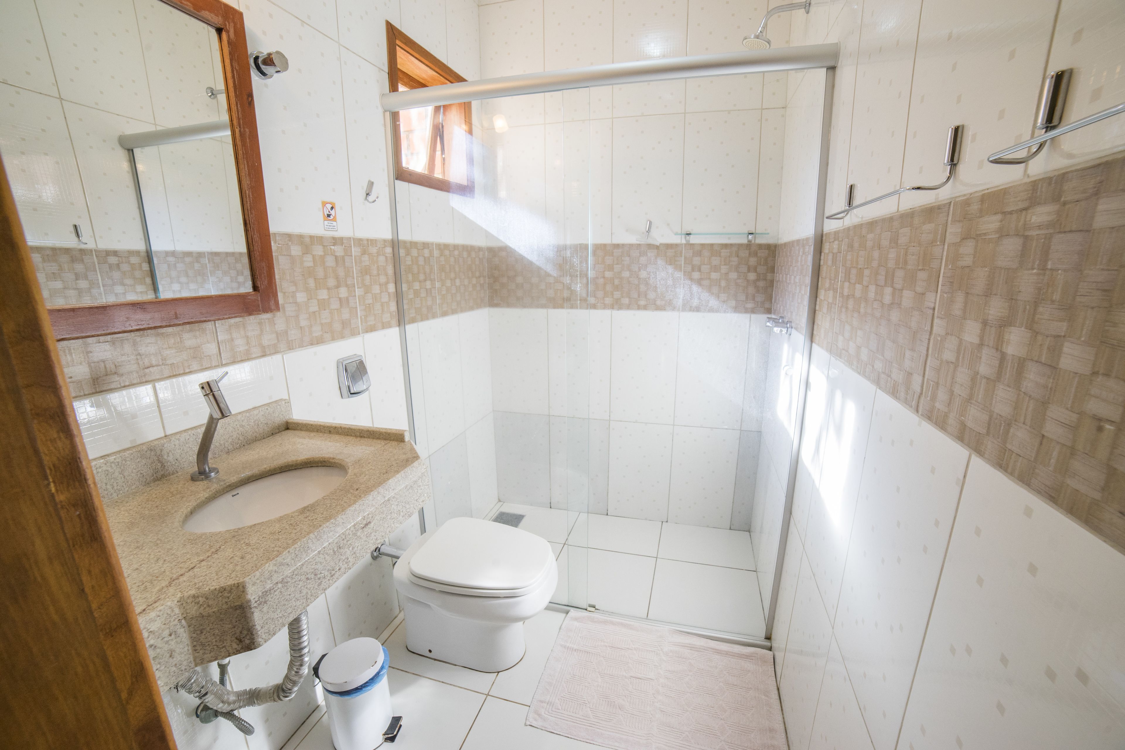 A bathroom with a sink, toilet, and shower area.