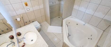 A modern bathroom with a bathtub, a sink, and a toilet.