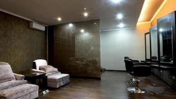 A modern interior with a seating area, a mirror, and a wall with a textured pattern.