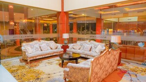 A lobby with two sofas, a coffee table, and a patterned rug. - Sutan Raja Hotel and Convention Cen (Soreang)