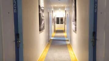 A hotel corridor with doors labeled 502 and 503, leading to rooms.