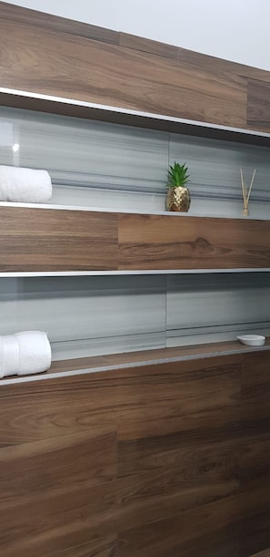 A bathroom with wooden paneling and a mirror.