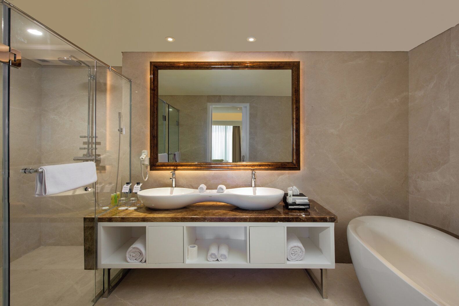 A modern bathroom with a glass shower enclosure, a double sink vanity, and a standalone bathtub.