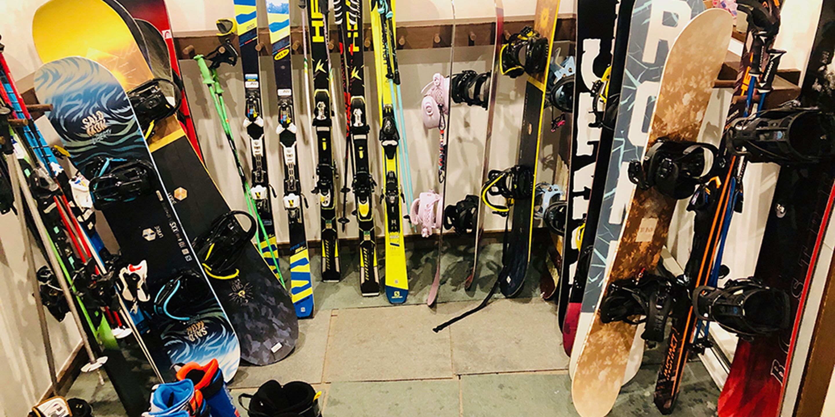 A ski equipment store with various skis and snowboards on display.