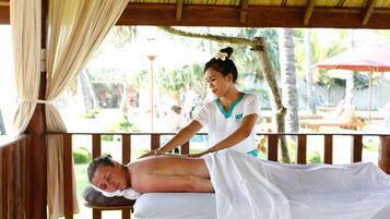 Experience rejuvenating massages in a serene outdoor setting, complete with a skilled therapist and soothing ambiance.