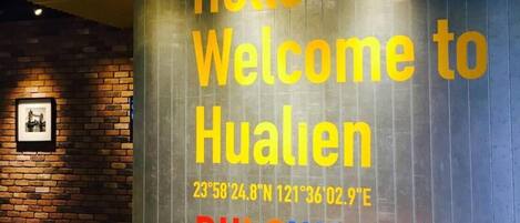 A wall with a welcome message and coordinates for Hualien, BULOWAN.