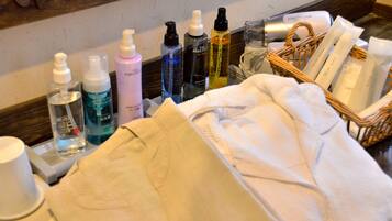 A bathroom counter with toiletries and a towel basket.