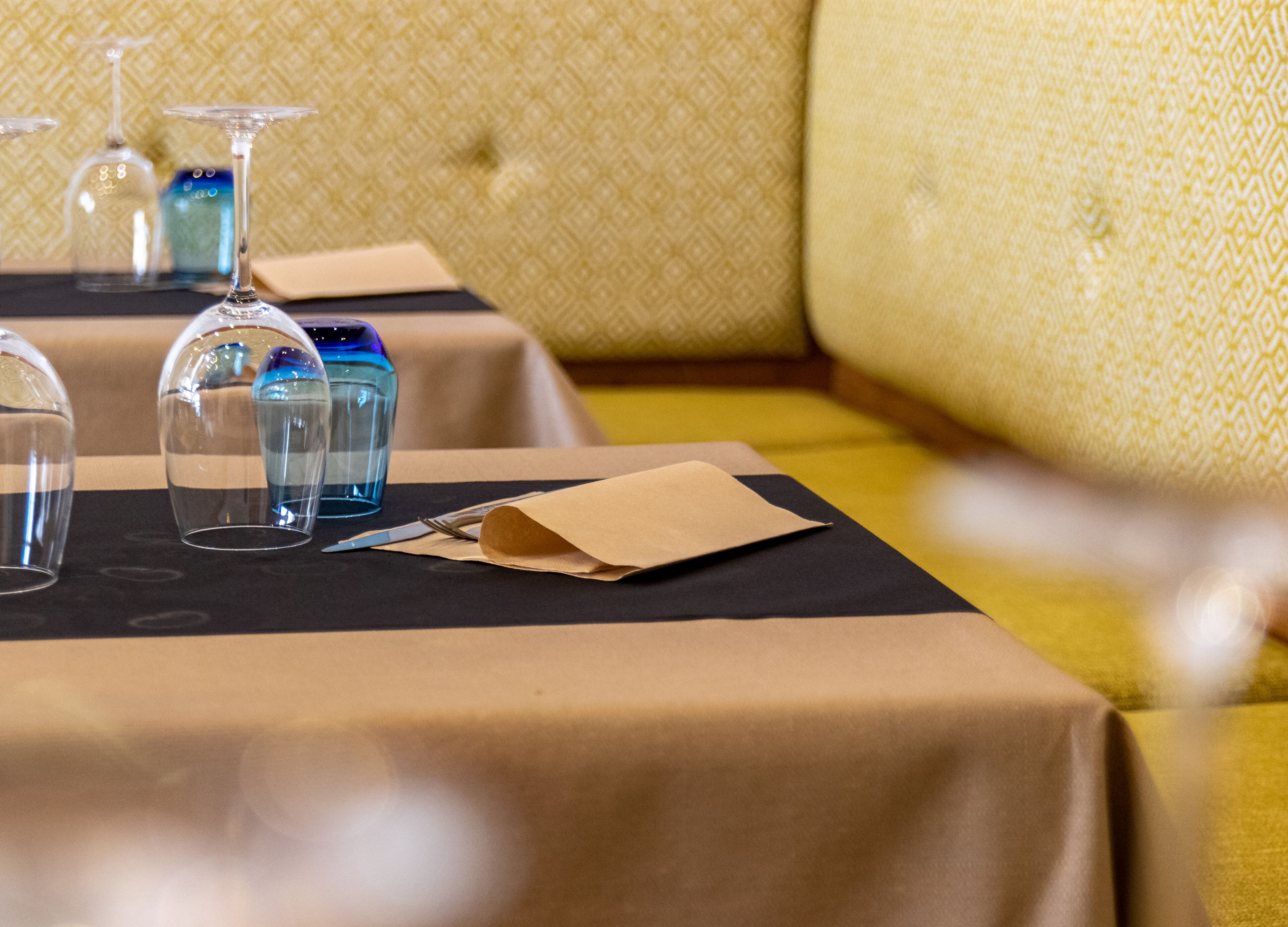 A table set with a napkin, a glass, and a water bottle.