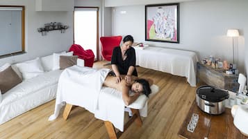 Experience a serene massage therapy area with a dedicated table and expert care.