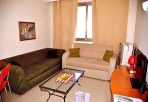 Family Apartment, 1 Bedroom, Sea View, Beachfront | Living area | Flat-screen TV - Apartment by the Sea (Haifa)