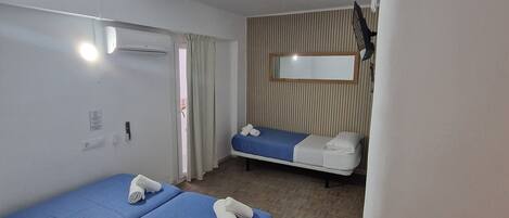 Economy Triple Room, Private Bathroom | In-room safe, individually furnished, blackout drapes, free WiFi