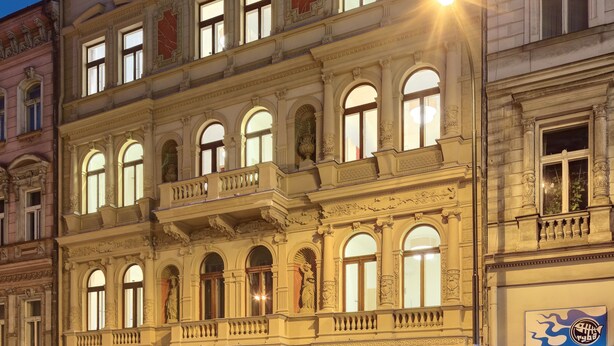 A historic building with multiple floors, featuring a ground-level restaurant, a café, and a hotel. - Salvator Boutique Hotel (Prague)