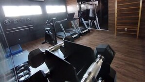 A gym with treadmills, a stationary bike, and a rowing machine.
