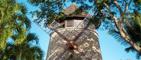 A windmill with a wooden structure and metal lattice.
