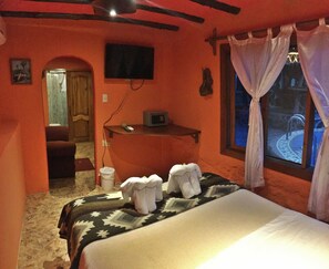 Bedroom #1 | Premium bedding, down duvets, memory-foam beds, in-room safe - Lonesome George Ecolodge (Puerto Ayora)