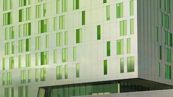 A modern hotel building with a glass facade, labeled "Courtyard by Marriott."