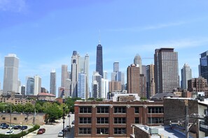 A city skyline with various high-rise buildings, including a prominent skyscraper. - The Chicago Hotel Collection River North (Chicago)