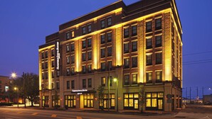 A multi-story hotel with a brick facade and illuminated windows. - Fairfield Inn & Suites Savannah Downtown/Historic District (Savannah)