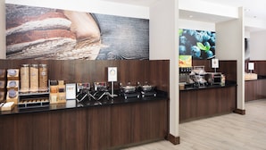 A breakfast bar with various food items and a coffee machine. - Fairfield Inn & Suites Savannah Downtown/Historic District (Savannah)