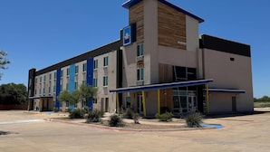 A modern hotel with a flat roof, multiple windows, and a blue and white color scheme. - Days Inn & Suites by Wyndham Colorado City/I-20 (Colorado City)