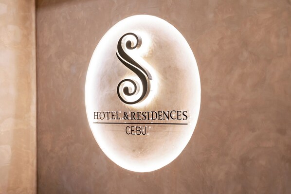 A sign with a stylized 'S' logo and the text 'HOTEL & RESIDENCES CEBU'. - S Hotel and Residences (Cebu City)