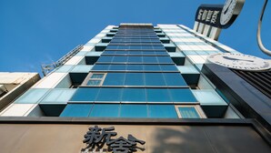 Un bâtiment moderne doté d’une horloge bien visible et d’une signalétique indiquant qu’il est dédié à la découverte.