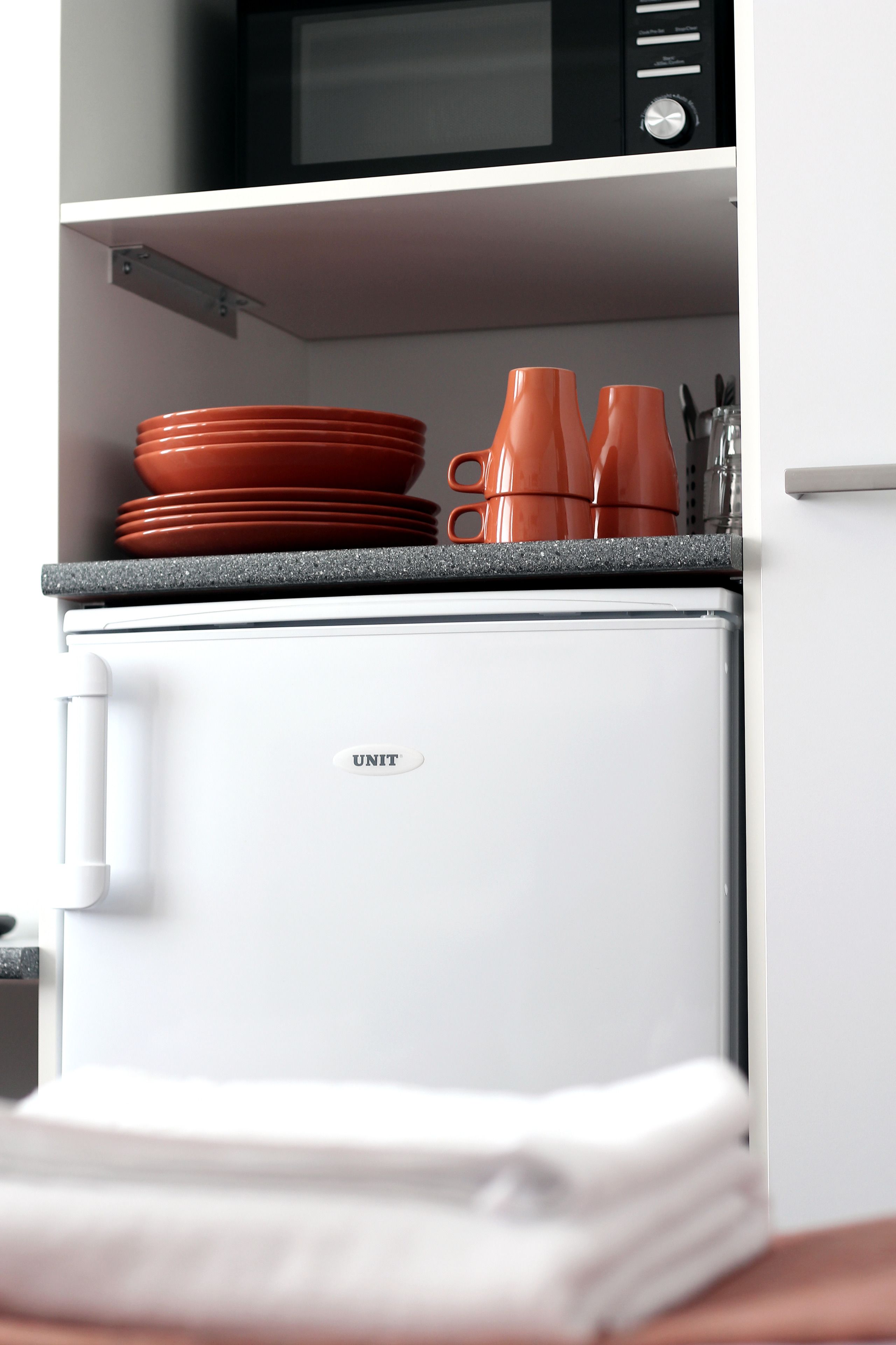 microwave, coffee/tea maker, electric kettle, cookware/dishes/utensils