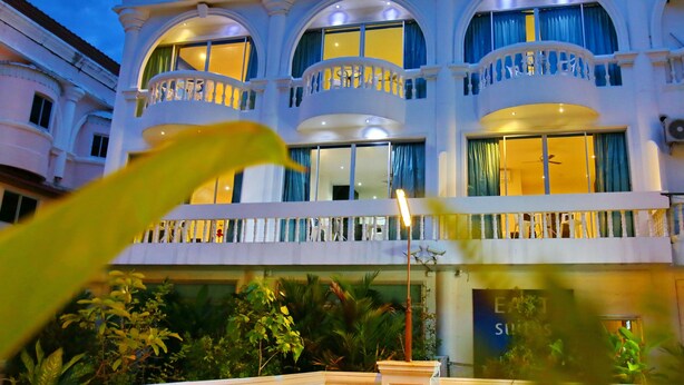 A multi-story hotel with balconies and large windows. - East Suites (Pattaya)