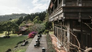 A traditional wooden building with a wooden deck and outdoor seating area. - The One Nanyuan (Xinpu)