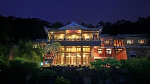 A traditional building with a multi-story structure, large windows, and a balcony. - The One Nanyuan (Xinpu)
