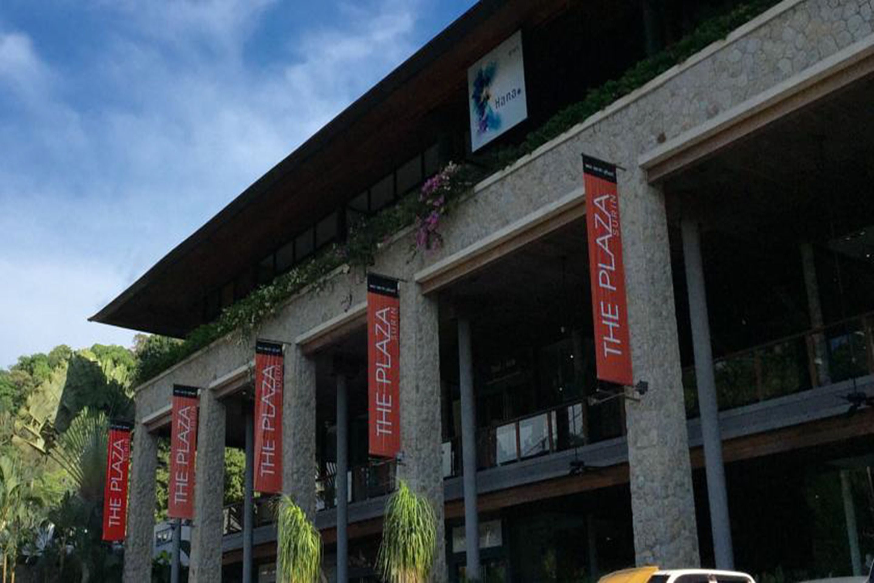 A building with multiple banners reading "The Plaza."