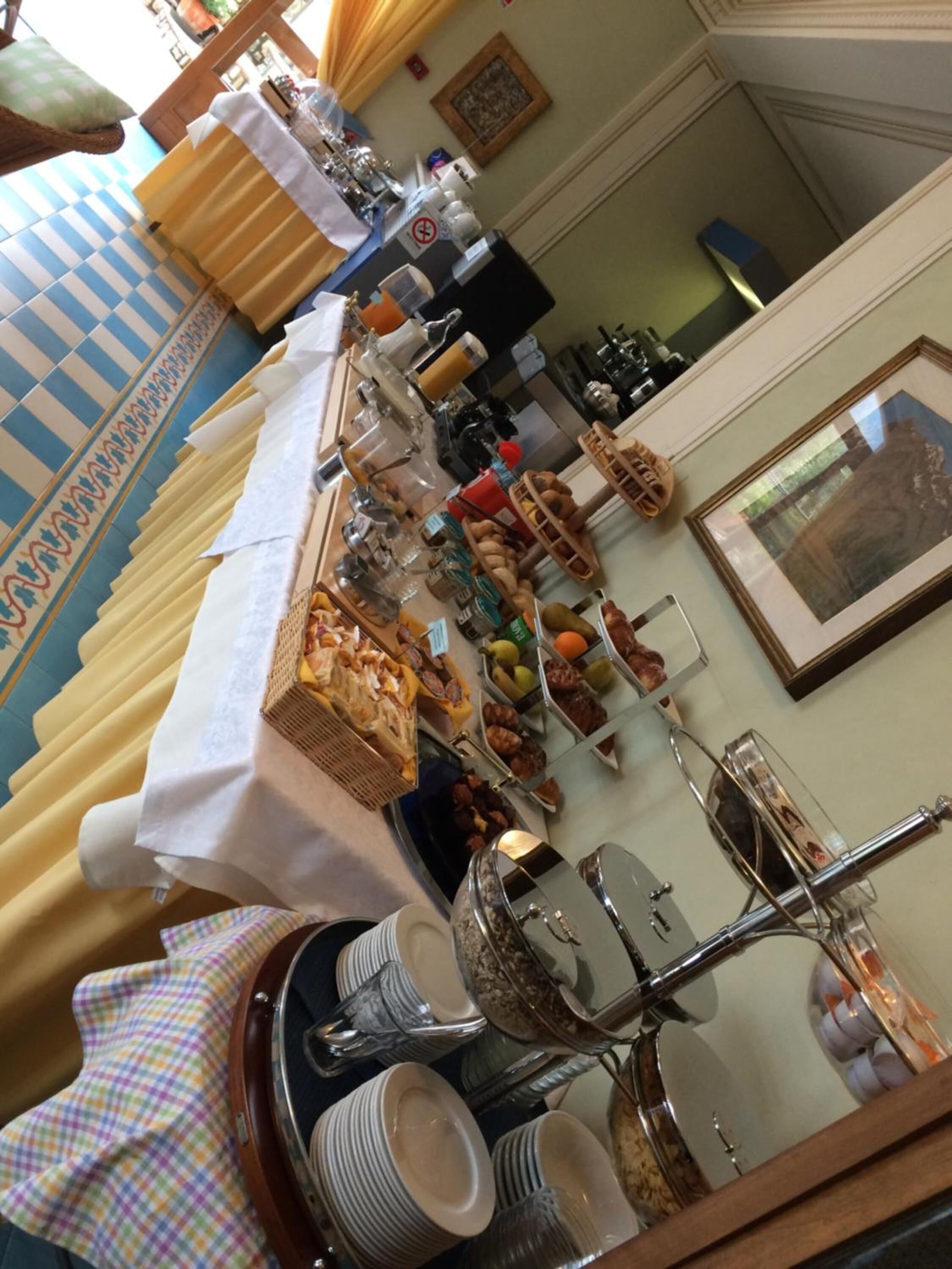 A buffet setup with various food items and a coffee station.