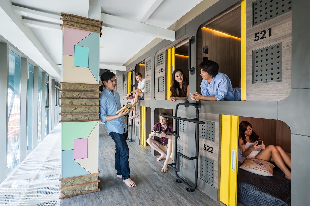 A modern hotel interior with bunk beds, each with a unique number.