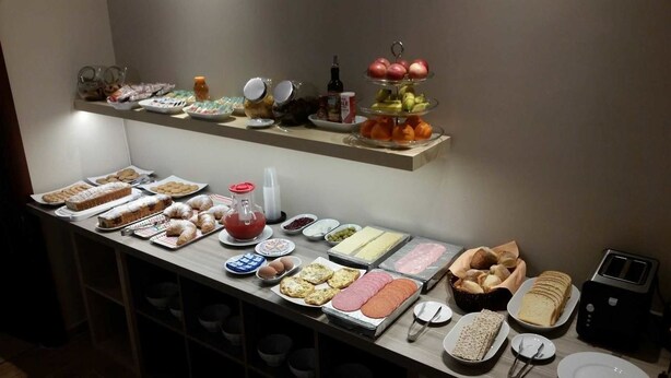 A buffet with various food items including pastries, meats, and fruits. - La Maison des Rêves (Syracuse)