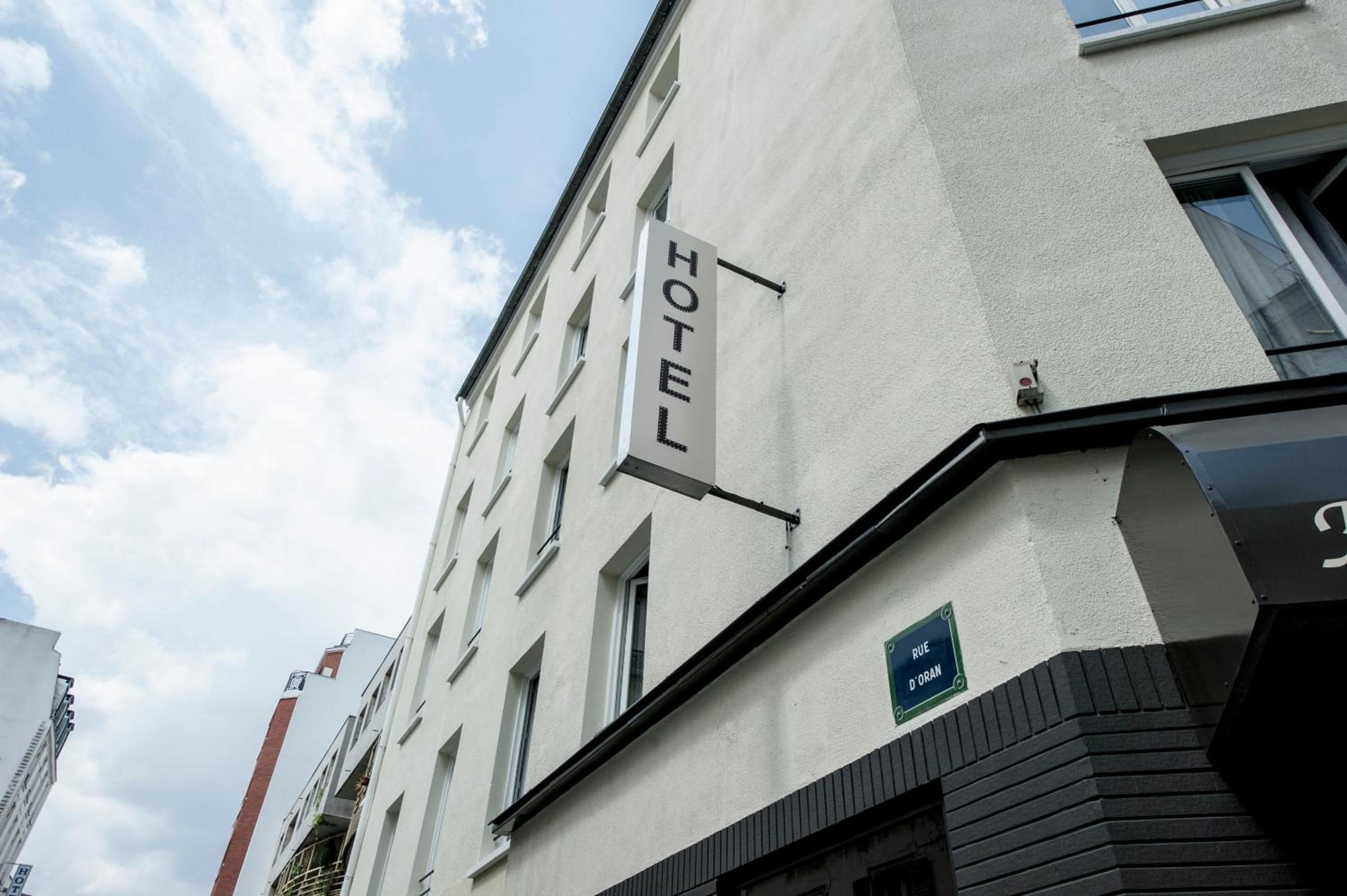 A hotel building with a sign indicating 'HOTEL' on the facade.