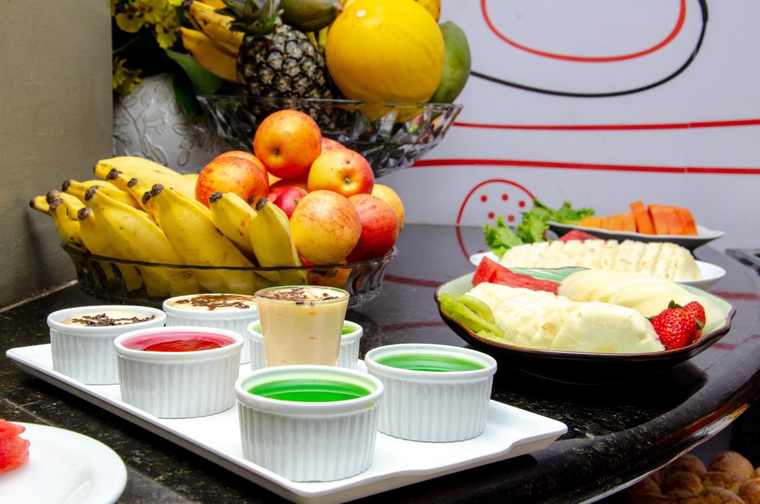 A fruit bowl with bananas, apples, and a pineapple.