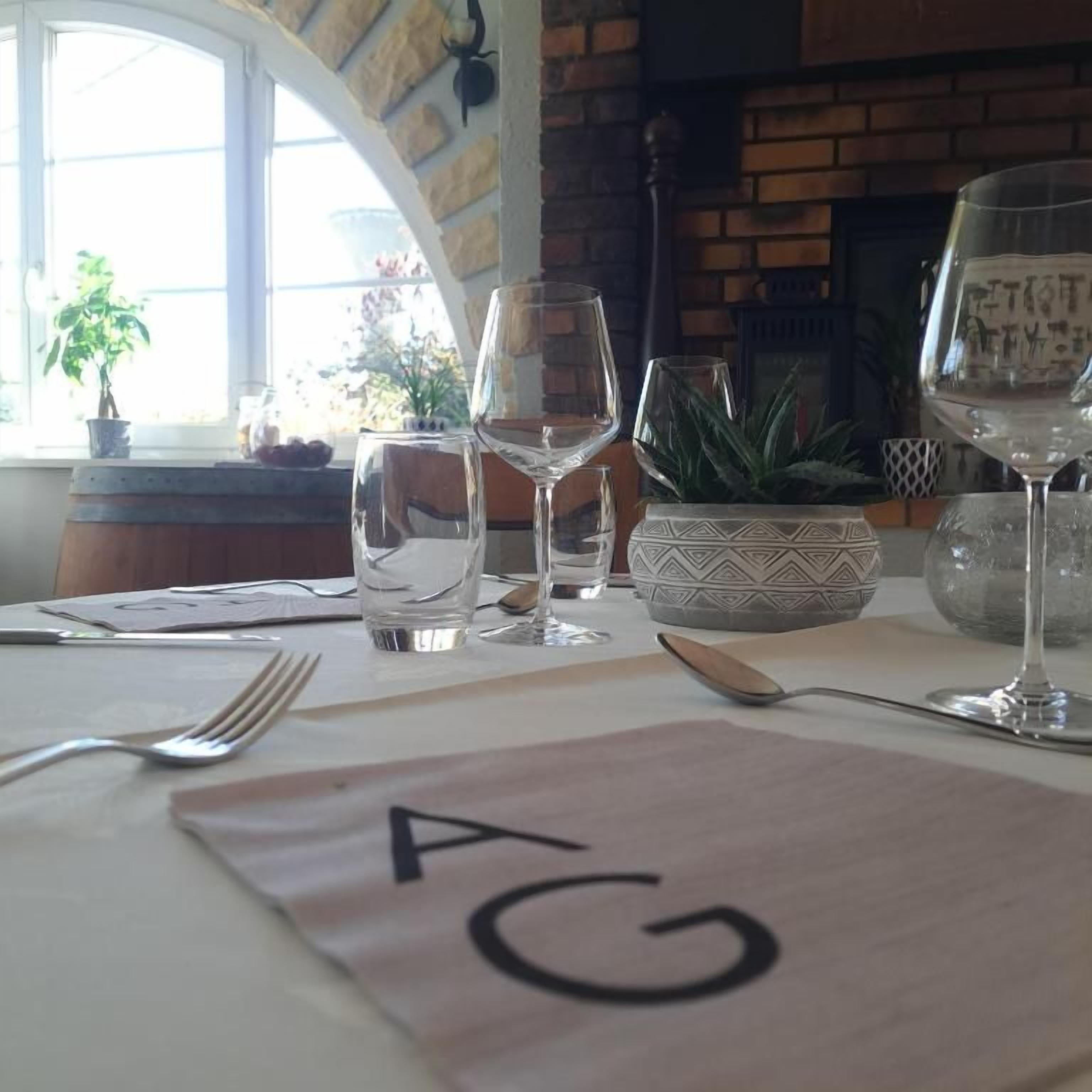 A dining table with a placemat marked 'A5' and several wine glasses.