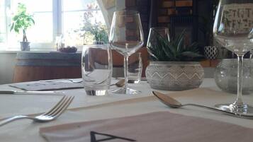 A dining table with a placemat marked 'A5' and several wine glasses.