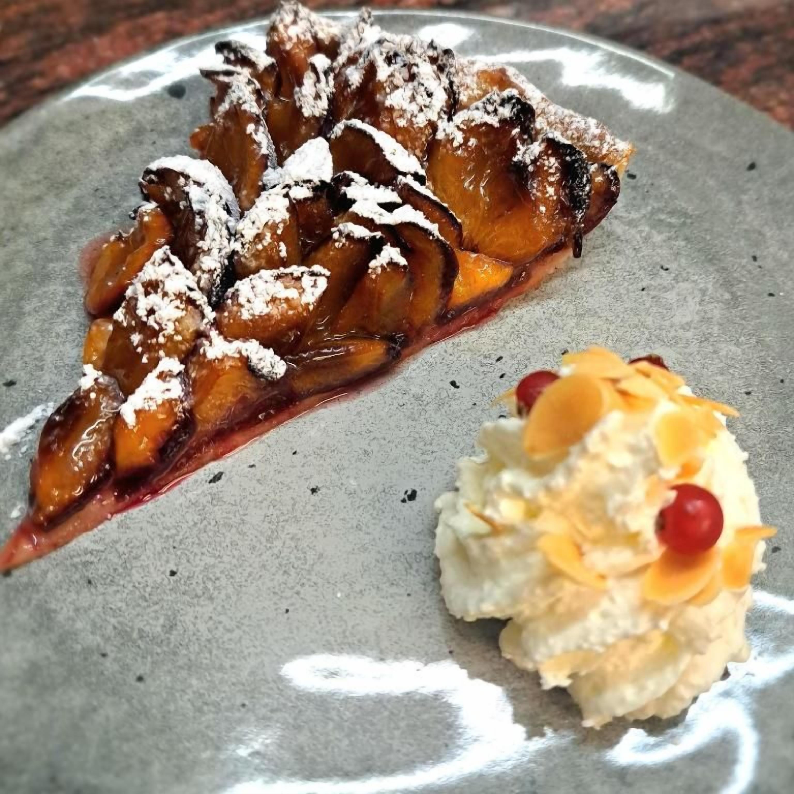 A dessert plate with a slice of pie and a scoop of ice cream.