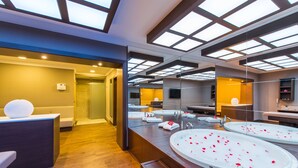 A modern bathroom with wooden flooring, a reception desk, and a large mirror reflecting the space. - Radisson Blu Hotel, Ordu (Ordu)