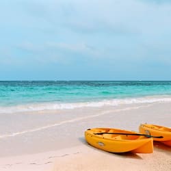 On the beach, white sand, sun-loungers, beach umbrellas