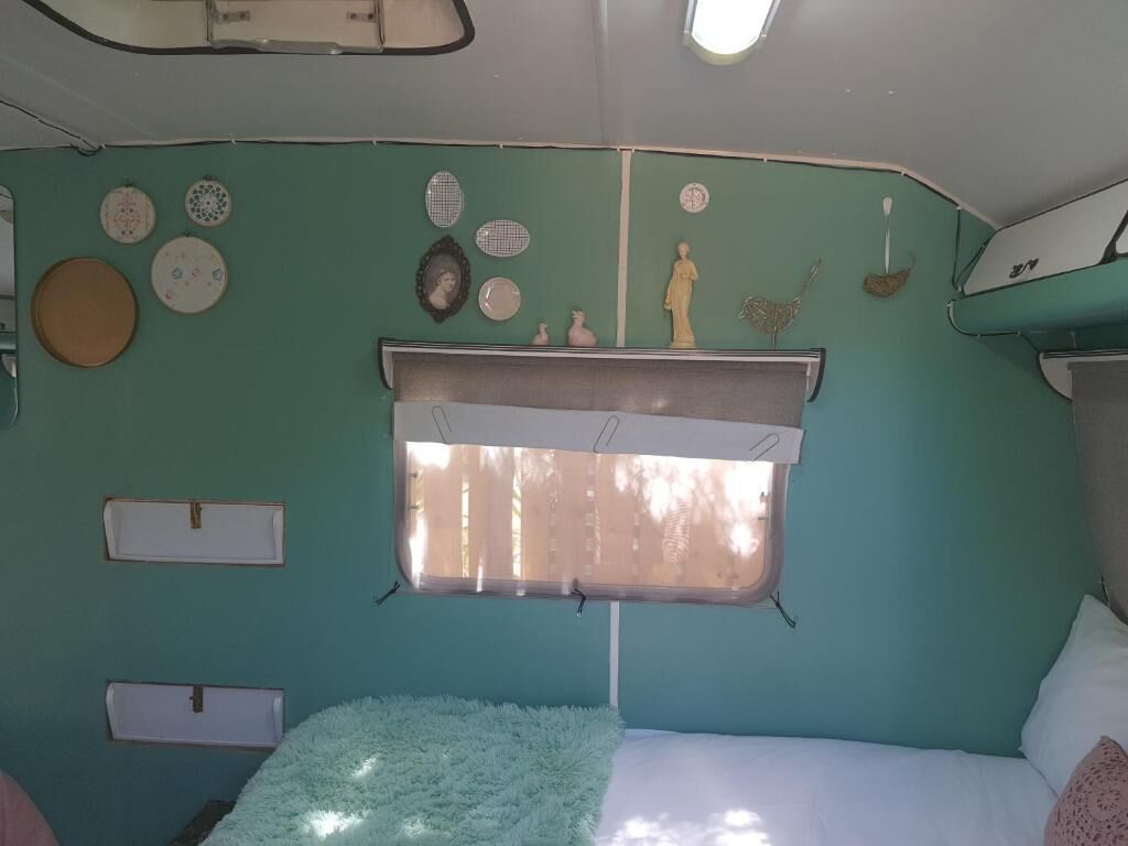 Une chambre à coucher avec un lit, une fenêtre et des éléments d écoratifs sur les murs.
