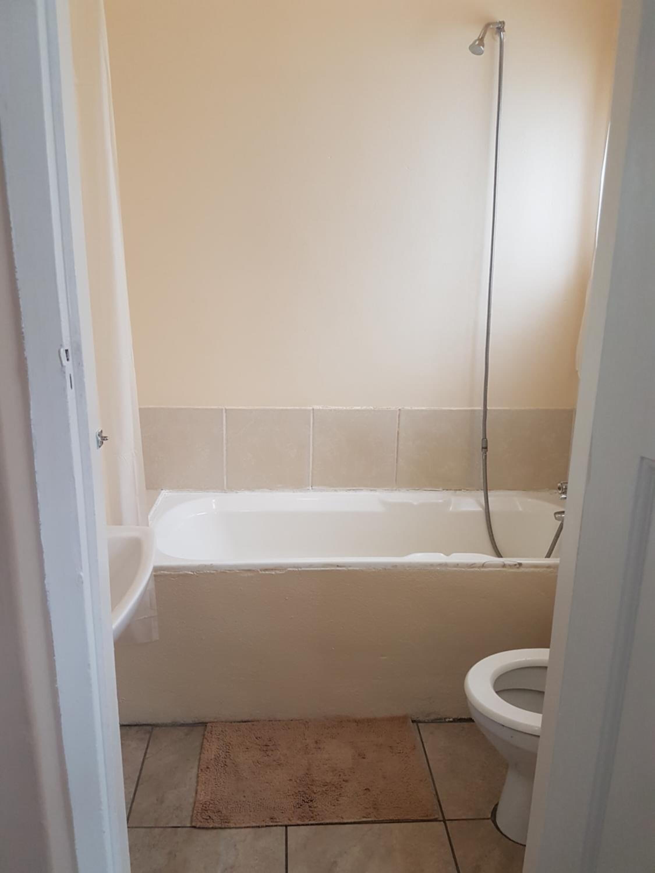A bathroom with a bathtub, toilet, and a shower.